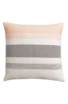 an orange and grey striped pillow on a white background