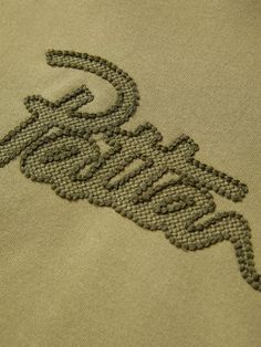 an embroidered logo on the back of a t - shirt