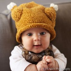 a baby wearing a knitted hat and scarf with the words adorable newborn & baby hats