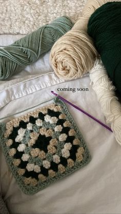 two crocheted grannys are laying next to each other on a white blanket