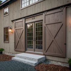 an exterior view of a building with wooden doors and windows