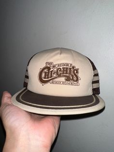 Vintage Chi Chi's Hat  - Rare  - 80's vintage  - Brown tonal  - Chi Chi's The Incredible Mexican Restaurant  - Three bar  - Trucker hat style  SnapBack OSFA  Good vintage condition No rips or holes  No stains Vintage Adjustable Snapback Hat With Curved Brim, Retro Brown Adjustable Hat, Vintage Adjustable Flat Bill Fitted Hat, Vintage Adjustable Flat Bill Hat, Vintage Flat Bill Baseball Cap, Retro Fitted Hat With Flat Bill, Retro Brown Hats, One Size Fits Most, Retro Brown Baseball Cap With Short Brim, Retro Brown Hats One Size Fits Most