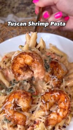 pasta with shrimp and parmesan cheese in a white bowl