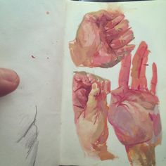 an open book with pink and orange hand prints on the pages, next to a pencil drawing of two hands