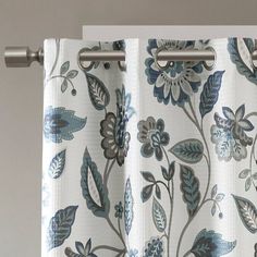 a curtain with blue and white flowers hanging from it's grommet rod