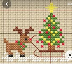 a cross stitch christmas scene with a reindeer pulling a sleigh and a tree