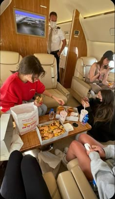 people are eating food in the middle of an airplane