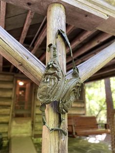 a wooden post with a metal bag hanging from it's side