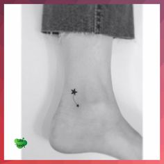 a black and white photo of a person's foot with a star tattoo on it