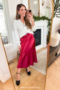 This red satin skirt outfit is stunning! It's perfect for a Christmas party outfit, date night outfit, or winter wedding guest outfit. This midi skirt is so stretchy, comfy, and easy to style for a classy holiday outfit. I'm styling a red skirt with a white bow sweater, and black heels for a semi formal holiday party outfit. these skirts with sparkly bow heels and a black bodysuit. Shop these holiday outfit for winter now! #affiliatelink Red Skirt White Top Outfit Christmas, Satin Skirt Outfit Christmas, Red Skirt Winter Outfit, Semi Formal Holiday Party Outfit, Semi Formal Christmas Party Outfit, Red Silk Skirt Outfit, Winter Tea Party Outfit, Red Skirt Winter, Red Satin Skirt Outfit