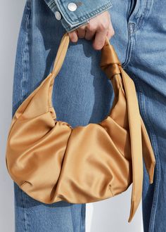 Ruched tote bag detailed with an artfully knotted oversized knot. Made from glossy satin, finished with magnetic closure.    Width: 23cm / 9”Total height: 30cm / 11.8”Handle drop: 13cm / 5.1” Elegant Shoulder Bag With Loop Closure For Daily Use, Chic Shoulder Bag With Loop Closure, Elegant Evening Bag With Loop Closure, Elegant Evening Bags With Loop Closure, Chic Bags With Loop Closure For Daily Use, Elegant Daily Use Bag With Loop Closure, Chic Satin Bags With Satin Finish, Flared Skirt Dress, Summer Style Guide