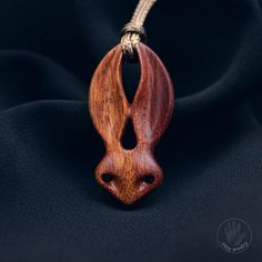 Wood jewelry crafted from bloodwood, this rabbit head pendant is an exquisite accessory that captures attention with its uniqueness and refined design. Each pendant is one-of-a-kind due to the natural variations in the wood, adding a special charm to every piece. With expert craftsmanship and the use of natural materials, this pendant makes an excellent gift for nature-inspired enthusiasts.    [CARE] The pendant is sealed with two or more layers of wood oil in order to protect the wood against m Rabbit Necklace, Rabbit Head, Wood Oil, Wooden Necklace, Dragon Pendant, Wood Jewelry, Cord Necklace, Wood Jewellery, Wooden Jewelry