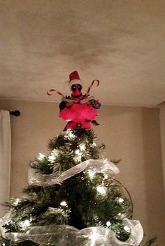 a decorated christmas tree in the corner of a room