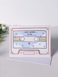 a card with an old fashioned cassette tape on it, and the words happy birthday to you