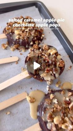 chocolate caramel apple pops with walnuts and pecans on a baking sheet, ready to be eaten