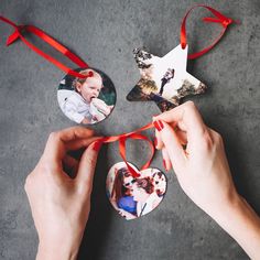 two hands holding ornaments in the shape of a star and a baby's photo