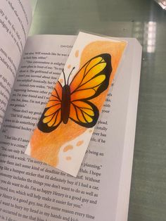 an open book with a butterfly on it