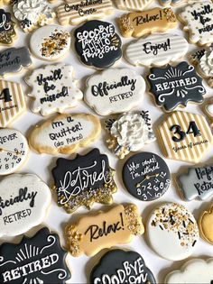 decorated cookies with black and white frosting are arranged on a table in the shape of hearts