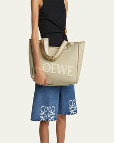 Loewe canvas cotton, linen, and leather tote bag with logo across front     Shoulder straps     Open top     Interior, one slip pocket     Approx. 11.9"H x 14.2"W x 6.6"D    Made in Spain Designer Large Capacity Canvas Bag, Designer Canvas Bags For Summer, Designer Summer Canvas Bags, Designer Canvas Bag For Errands, Summer Bag With Logo And Double Handle, Summer Double Handle Bag With Logo, Summer Bags With Logo And Double Handle, Canvas Shoulder Bag With Logo For Errands, Designer Summer Shoulder Bag With Logo