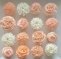 the cupcakes are decorated with pink and white icing flowers on top of each other