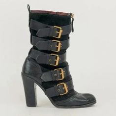 The Calf-Length Bomba Boots From Marc By Marc Jacobs Are Made In A Mix Of Black Textured Leather And Suede, And Feature A Stacked High Heel, A Closed Round Cap Toe, 5 Buckled Cross Straps With Antique Gold Tone Logo-Embossed Buckles, An Exposed Gold-Tone Front Zip, An Exposed Zip Closure On The Inner Side, A Small Vertical Seam At The Heel Cap, Pull Tabs At The Heel Collar, And Leather Lining And Soles. Condition: Fair; Chipping On Heels, Heavy Wear On Outsoles, Marks On Toes, Counters, And Sued Midcalf Boots, Marc Jacobs Shoes, Jacob Black, Heel Caps, Goat Leather, Cross Straps, Marc By Marc Jacobs, Shoes Heels Boots, Antique Gold