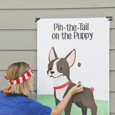 a woman holding up a sign with a dog on it's front and side