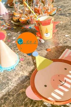 an animal themed birthday party with cupcakes and paper hats