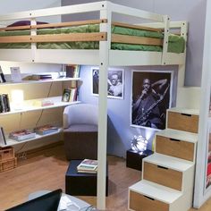 a loft bed with stairs leading up to it