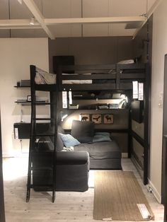 a living room with bunk beds and couches