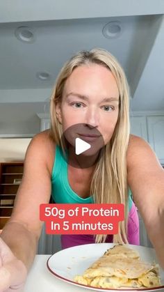 a woman sitting at a table with a plate of food in front of her and the caption 50g of protein in 5 minutes