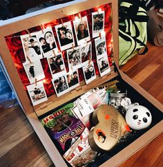 an open box with pictures and other items inside