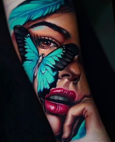 a woman's face with a butterfly painted on it