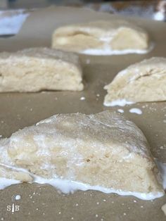 doughnuts with icing sitting on top of a baking sheet, ready to go into the oven