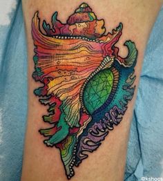 a colorful tattoo on the leg of a woman