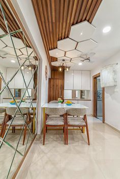 the dining room table is surrounded by chairs and scaffolding in front of a mirror