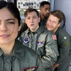 a group of men and women in pilot's uniforms posing for a photo together