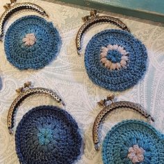 four crocheted purses sitting on top of a table