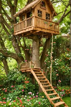 a tree house built into the side of a tree with stairs leading up to it