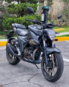 a black motorcycle parked in a parking lot