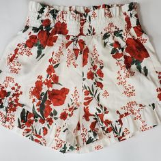 Floral Lined, High Waisted Pinup Style Shorts. 15" Elastic Waist 16" Length 3" Inseam 98% Polyester 2% Viscose Red Floral Print Summer Bottoms, Summer Floral Print Red Bottoms, Red Floral Print Short Length Bottoms, Red Floral Print Beach Shorts, Red Summer Shorts With Elastic Waistband, Red Elastic Waistband Shorts For Summer, Red Shorts For Beach In Spring, White Floral Print Summer Shorts, Red Bottoms With Elastic Waistband For Summer