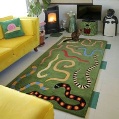 a living room filled with furniture and a green rug