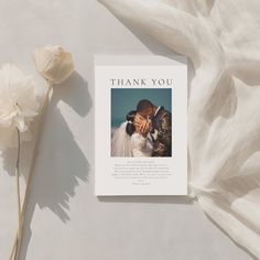 a thank card with a photo of a bride and groom on it next to flowers