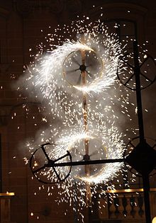 fireworks are lit up in the night sky above a clock tower with clocks on it