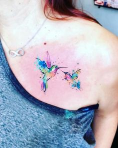 a woman with a tattoo on her chest has a hummingbird painted on it's shoulder