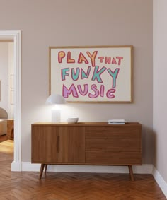 a room with a painting on the wall next to a wooden sideboard and lamp