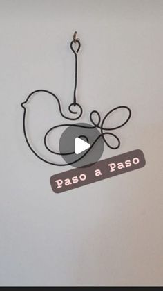 a sign that says paso a paso hanging from a hook on the side of a wall