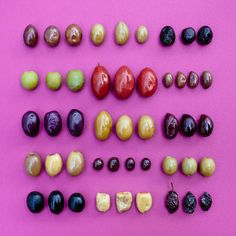 several different types of fruit on a pink surface