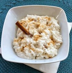 a white bowl filled with mashed potatoes on top of a blue place mat