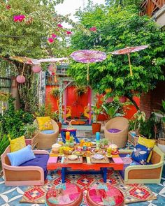 an outdoor patio with colorful furniture and umbrellas