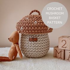 a crochet mushroom basket with a teddy bear next to it